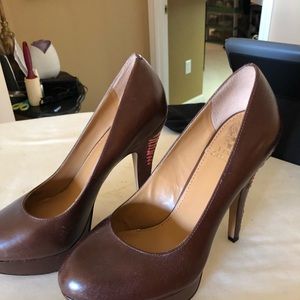 Brown pumps with orange lacing on heel